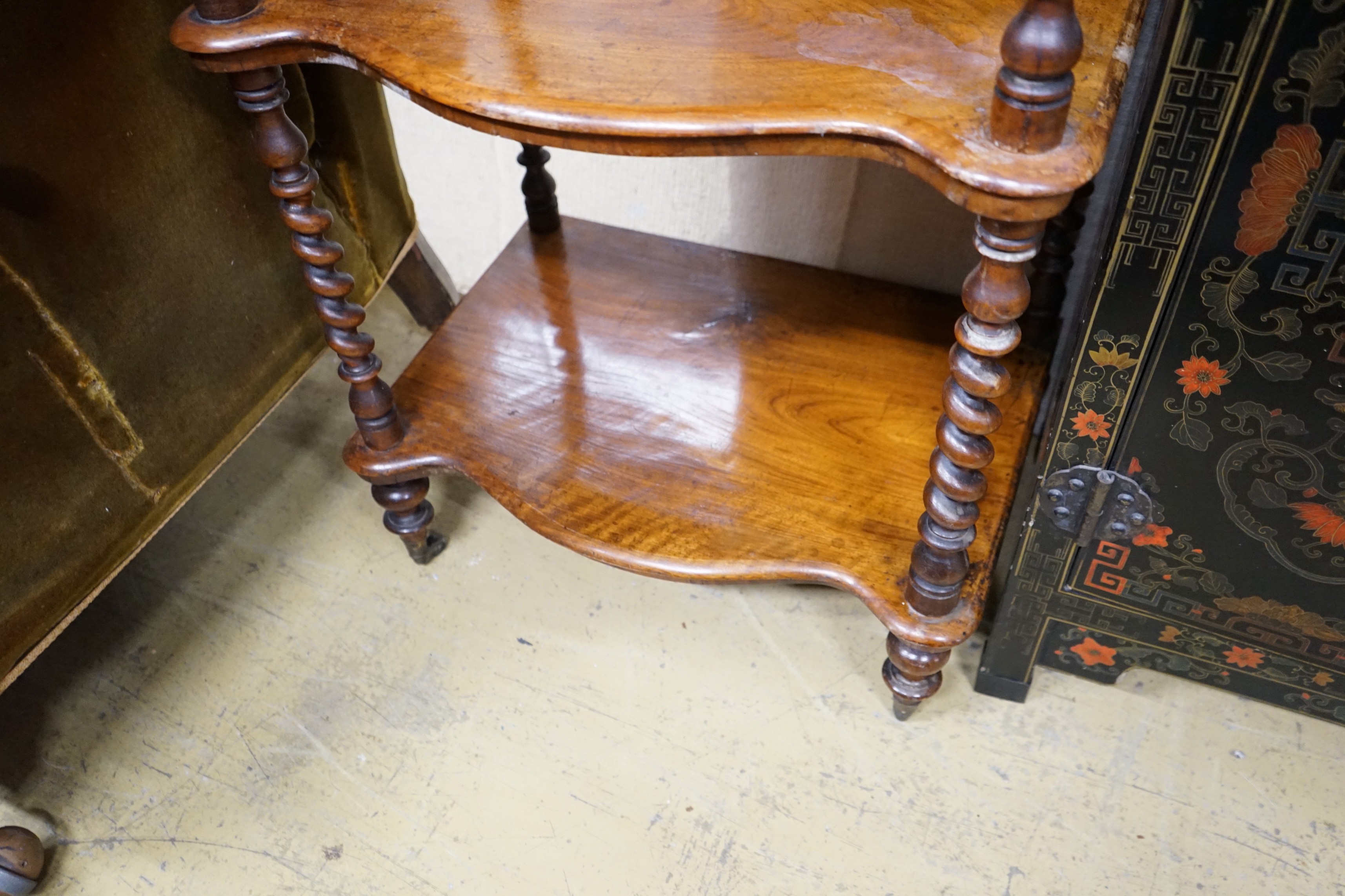 A Victorian walnut serpentine three tier whatnot, width 54cm, depth 38cm, height 104cm